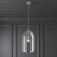 Clear glass and nickel banded pendant hanging from a grey paneled ceiling against a a grey painted wall.