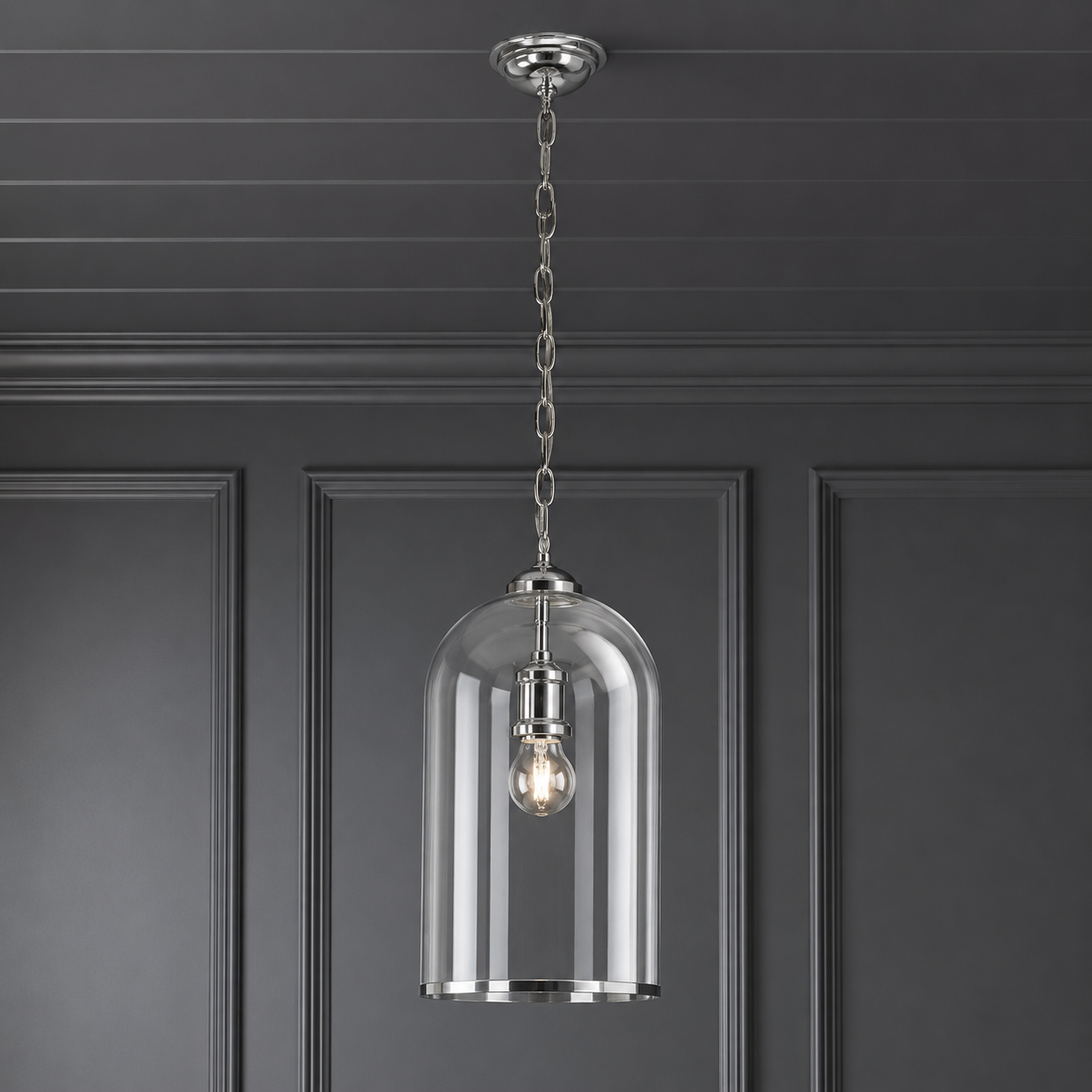 Clear glass and nickel banded pendant hanging from a grey paneled ceiling against a a grey painted wall.