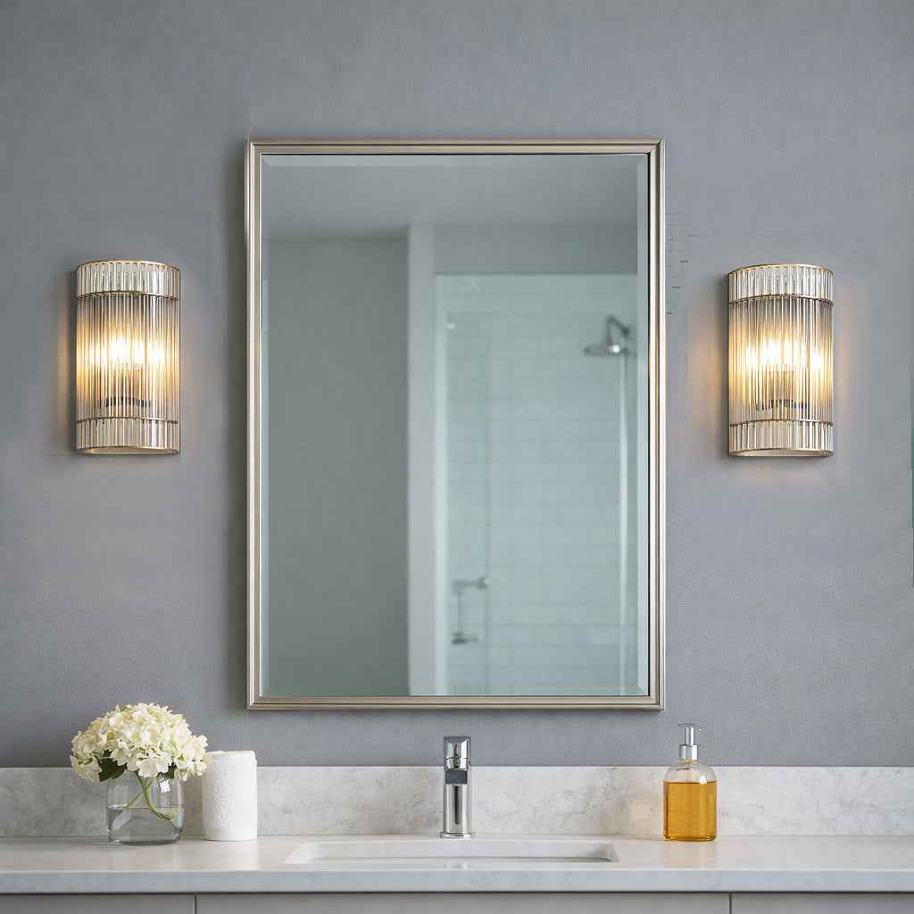 Vertical glass rods on a brass metal base, a bathroom wall light IP65 rated, 