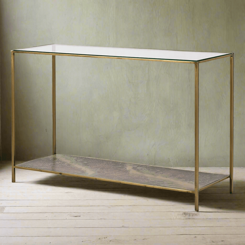 Glass topped console with lower oxidised metal shelf.&nbsp; The effect of the lower shelf has a rich patina of deep bronzes, rusted reds and greens adding a time-worn aesthetic, stunning as it can be seen through the glass top of the table adding an unusual, vintage industrial twist to the table.&nbsp; Supported by four gilt metal legs and gilt frame. the overall effect of this piece is of luxury.