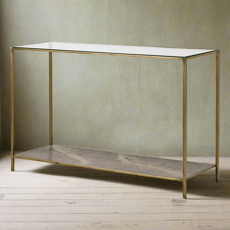 Glass topped console with lower oxidised metal shelf.&nbsp; The effect of the lower shelf has a rich patina of deep bronzes, rusted reds and greens adding a time-worn aesthetic, stunning as it can be seen through the glass top of the table adding an unusual, vintage industrial twist to the table.&nbsp; Supported by four gilt metal legs and gilt frame. the overall effect of this piece is of luxury.