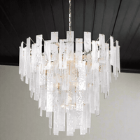Textured glass four tiered chandelier on a gilt metal frame, a statement in any room. Sixteen bulbs glow through the glass, giving a diffused, ambient light. 