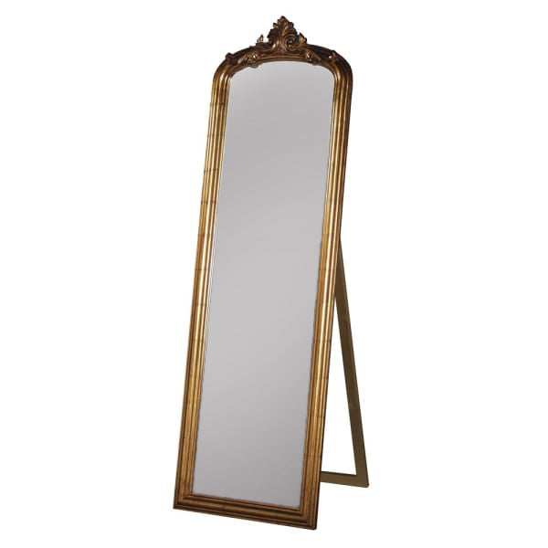 Tall, gold dressing mirror on stand with an ornate gold top.