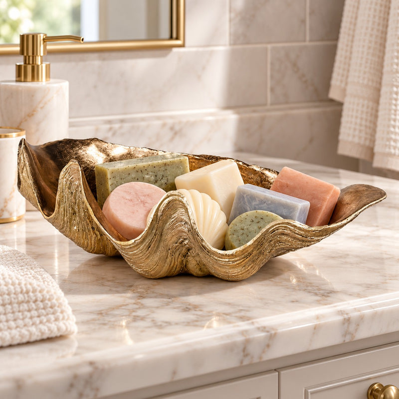 Gold resin shell on a marble bathroom surface holding soaps. 