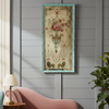 A tall, glass decorative wall hanging, in a distressed turquoise frame, the swags and floral detail on the distressed glass panel have a neoclassical look.The floral decoration has a faded grandeur and really gives the overall interior a vintage feel.The colours range from the deep pink of the flowers, the aqua blue of the vase and the two dark outward facing heraldic lions at the base of the panel, all together giving the appearance of a rococo revival decoration of earlier times.
