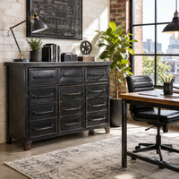 Black metal cabinet in an urban style home office with a desk, carpet and industrial style lighting.