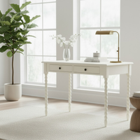 Ivory painted desk with two drawers and turned legs in a living room