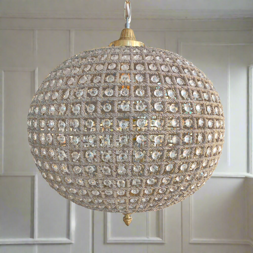 Large brass crystal globe chandelier with crystal beading encased in brass metalwork that reflects a pretty pattern around your ceiling and walls. A classic and glamorous ceiling light which compliments all types of decor.