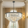 This five-tier chandelier brings timeless glamour and modern elegance together in one striking centerpiece. Its sleek black band frames cascading layers of crystal prisms, creating a dramatic waterfall effect that shimmers beautifully from every angle
