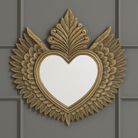 Decorative, large gold heart mirror with winged feather frame. 