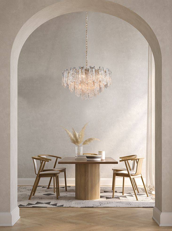 Icicle shard chandelier with textured glass panels at varying heights to refract the lights. It has 16 lights and aged brushed brass metal fittings.