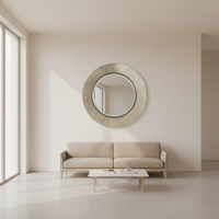 A really luxurious mirror, with a soft brushed finish. The gunmetal colour just adds to the really high end look. The mirror is sitting over a sofa in a minimalist sitting room. 