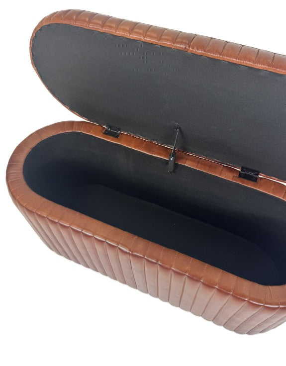 Side view of ribbed leather trunk with dark fabric lining on a white background. 