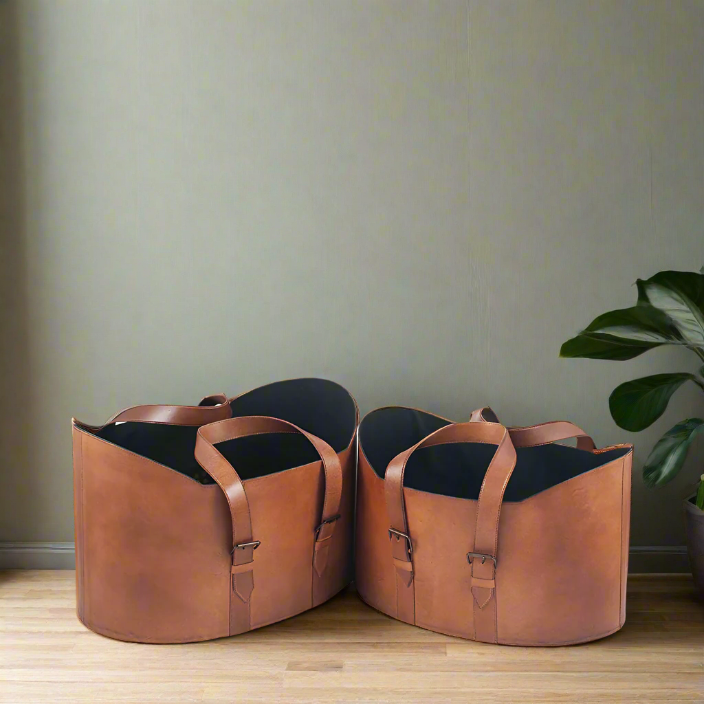 Pair of leather storage baskets on a wooden floor.