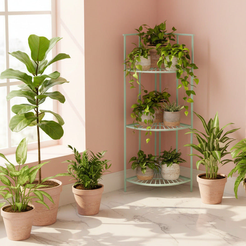 A three-tier corner shelving unit with a wire slatted design, painted in a light mint green color, shown in a minimalist gray room corner next to a small potted green plant.
