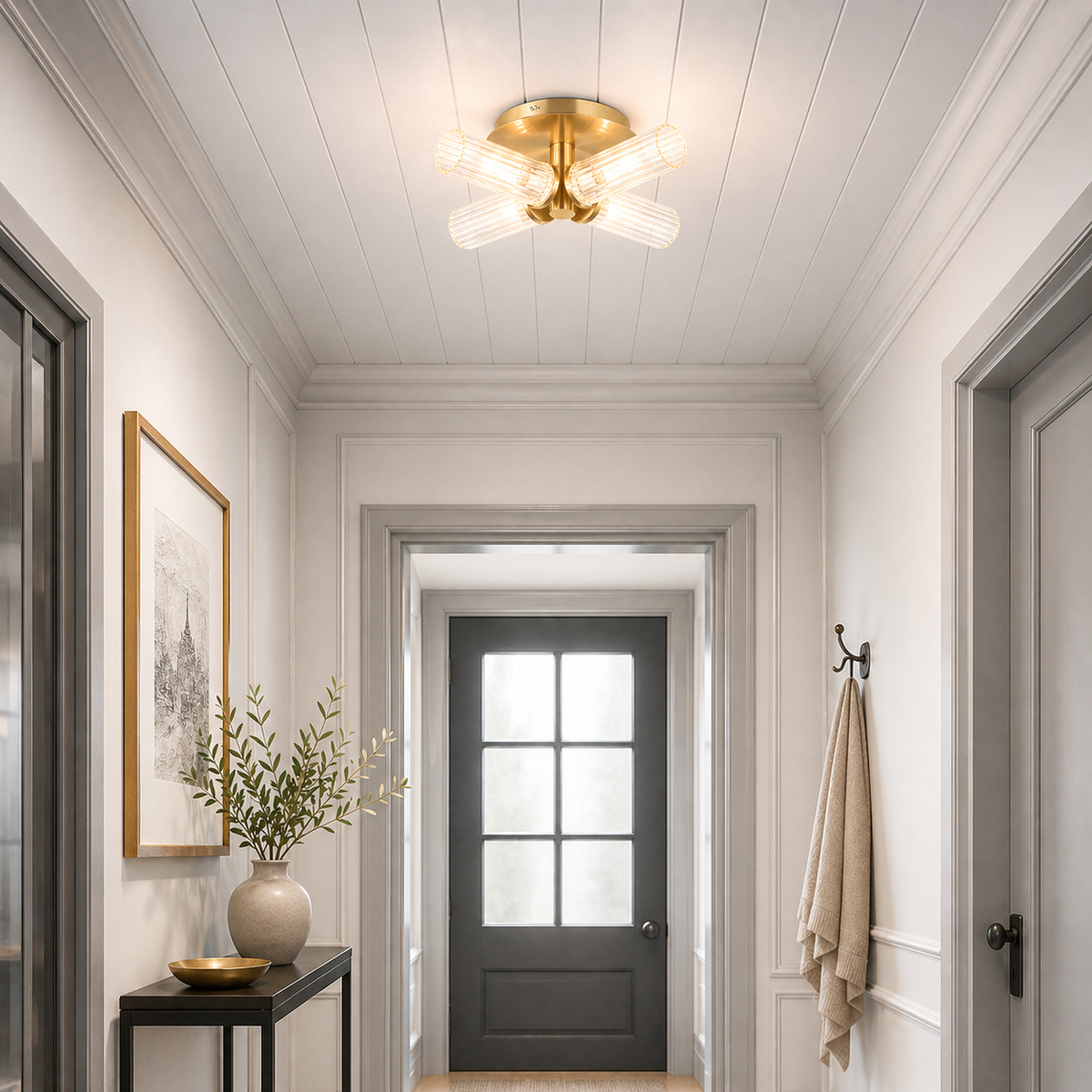 Modern hallway with flush, glass and gold ceiling light fixture, gray door, and decorative elements.