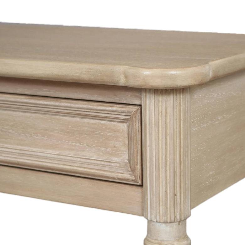 A classic long console table with two useful draws and lower shelf for storage. A hardwood piece made from Mindi wood, finished in an ash lime wash veneer finish. Close up of the top and leg.