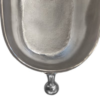 Close-up of a polished metallic silver object, showing a curved reflective surface  isolated on a white background.