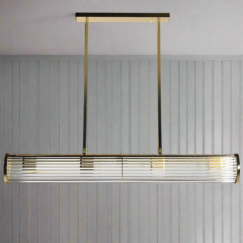 Long glass tubular, linear light, set on two gilt bars and a gilt coloured roof plate. The ends of the long bar are enclosed by two round gilt discs. Great Island light.