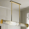 Long glass tubular, linear light, set on two gilt bars and a gilt coloured roof plate. The ends of the long bar are enclosed by two round gilt discs. Great Island light.