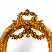 Medium-height arched wall mirror with a sculpted gold frame and floral swag crest, ideal for traditional interiors, hallways, bedrooms, or boutique displays. Detailed image.