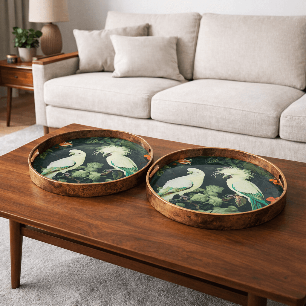 Two decorative trays with bird designs on a mid-century coffee table in a living room.