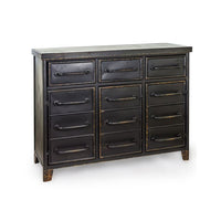A black industrial-style metal chest of drawers featuring multiple storage compartments, aged bronze-effect trim and tubular metal handles, designed with a vintage factory aesthetic suitable for contemporary and loft-style interiors.