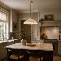Modern kitchen with marble island, pendant light, and decorative elements.