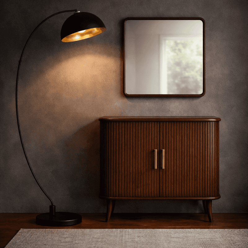 Wooden cabinet with a mirror and black floor lamp against a textured wall.