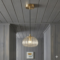 Modern pendant light with ribbed glass shade hanging from a wooden ceiling.