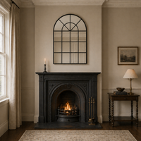 Cozy living room with a fireplace, mirror, and side table.