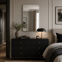 Modern bedroom with black drawers, industrial lighting and neutral walls.