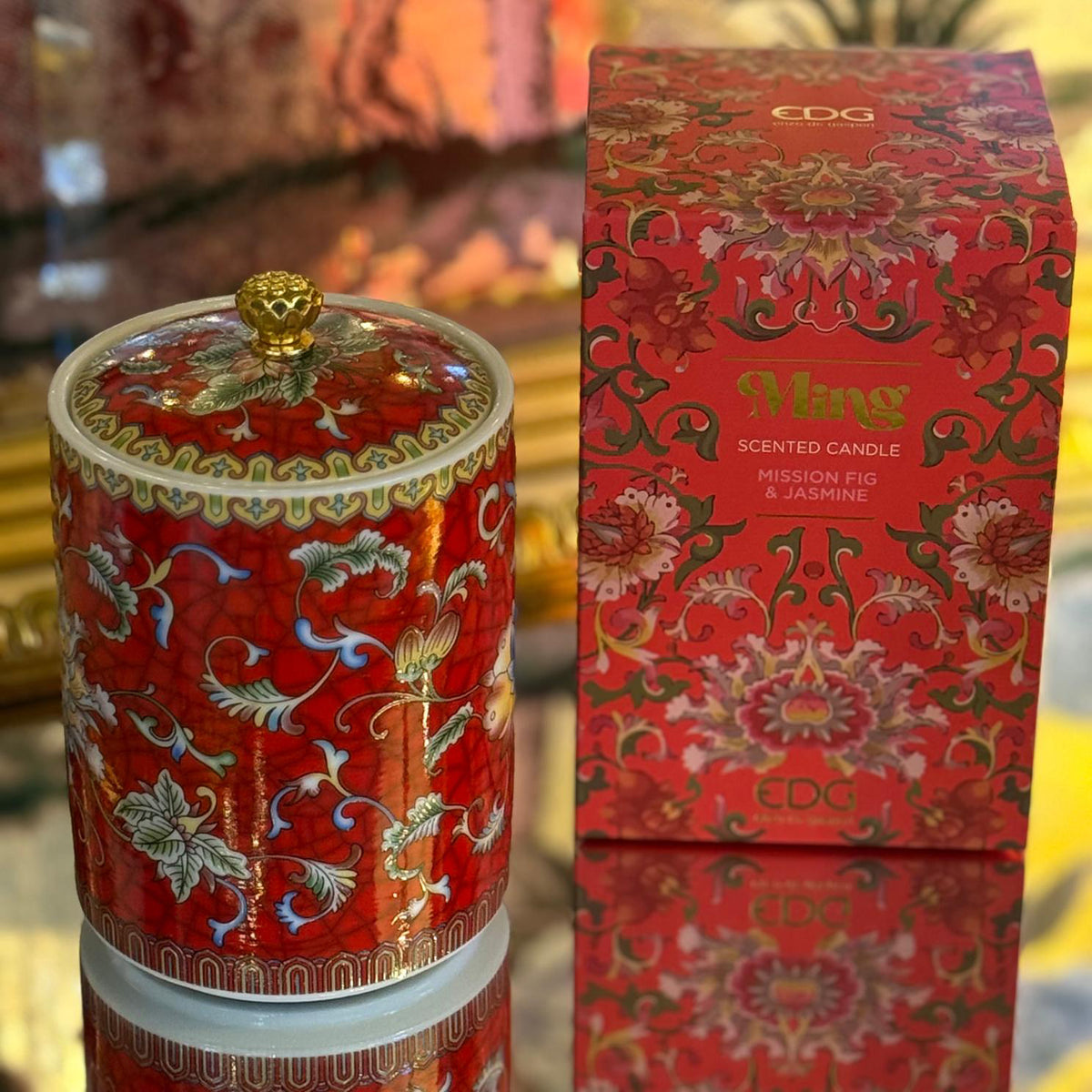 Handcrafted red ceramic scented candle jar with floral design and gold detailing, scented with Mission Fig and Jasmine.