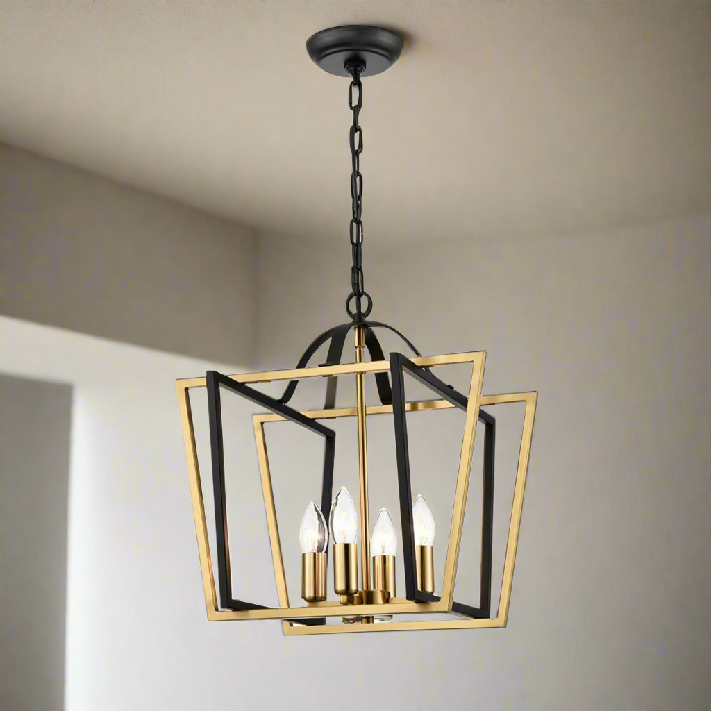 A contemporary pendant lantern light with a matt black and aged brass finish, featuring a geometric cage design with four bulb holders.