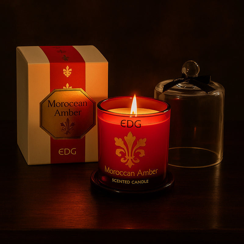Moroccan Amber luxury scented candle in red glass with gold detailing and a clear cloche, presented in a matching gift box.