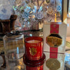 Moroccan Amber luxury scented candle in red glass with gold detailing and a clear cloche, presented in a matching gift box.