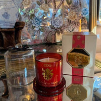 Moroccan Amber luxury scented candle in red glass with gold detailing and a clear cloche, presented in a matching gift box.