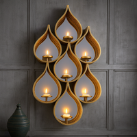 Tall teardrop-shaped mirror with pierced Moroccan-style metal frame and candleholders