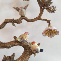Decorative wall art with birds and floral elements on a white background