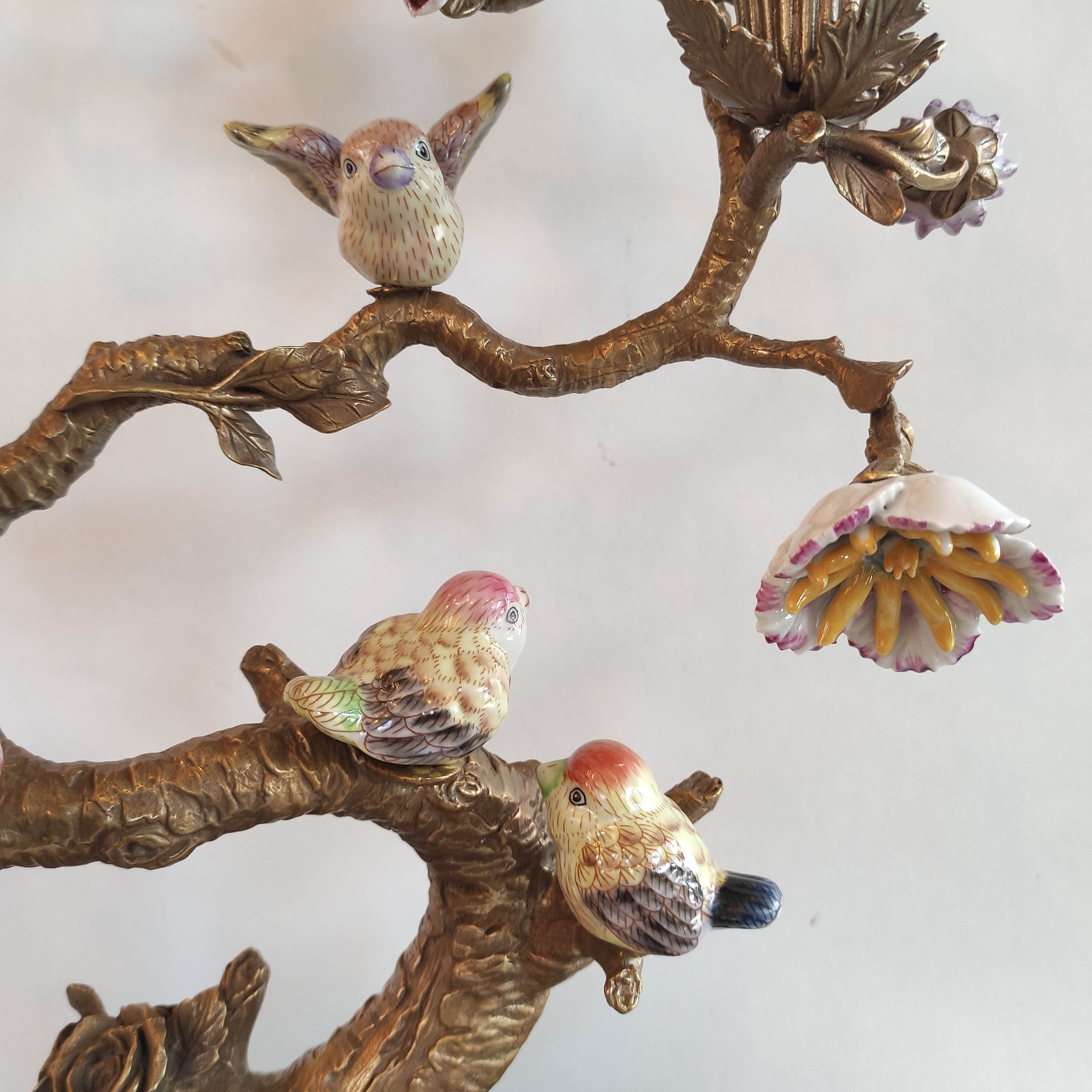 Decorative wall art with birds and floral elements on a white background