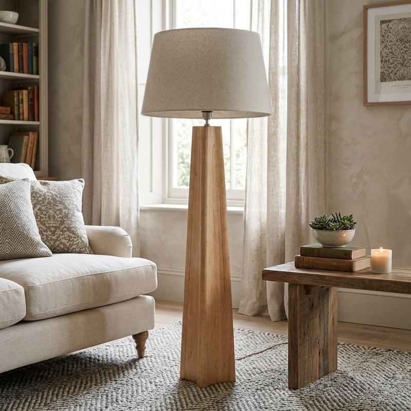 natural wood floor lamp with cream linen shade in a living room