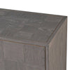 A sleek, contemporary long sideboard in a pale grey finish. This sideboard has four doors and has a particular stylish set of handles to the door in a dark gilt finish. There is a pattern of squares in the wooden surface of this piece. The sidebaord has four doors and two shelves behind each door, which provides ample 