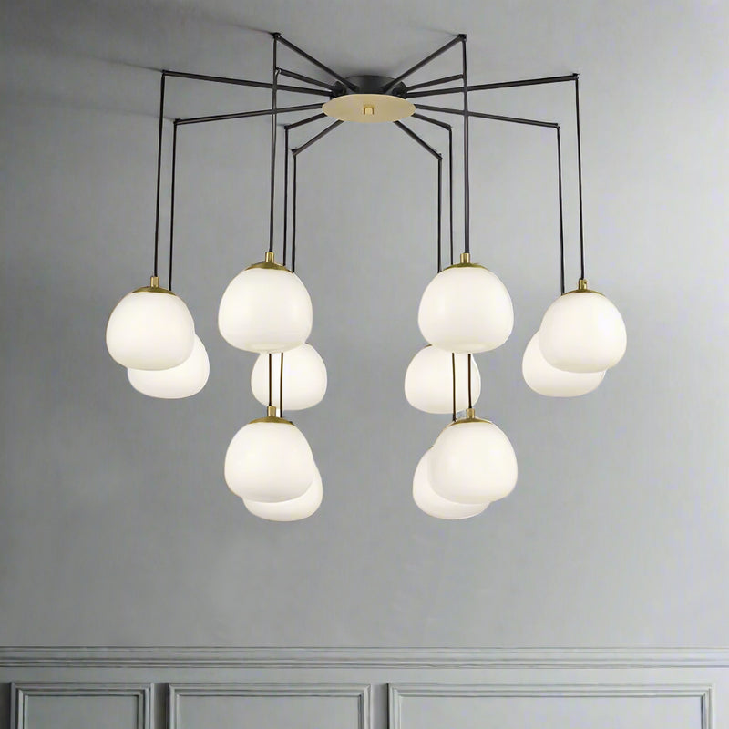 Total statement chandelier comprising 12 opal pendants on a beautifully structured matt black frame with brushed gold accents. 