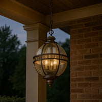 Outdoor bronze globe pendant light with clear seeded glass and classic lantern-style metal frame, IP44 rated for elegant exterior lighting.