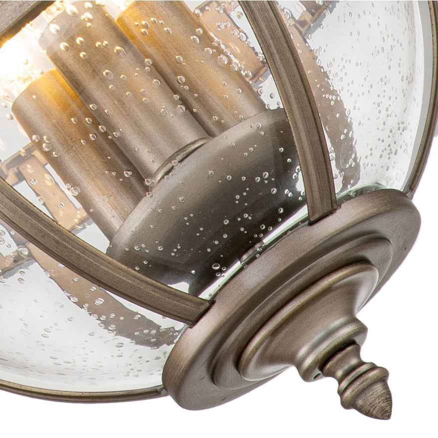 Outdoor bronze globe pendant light with clear seeded glass and classic lantern-style metal frame, IP44 rated for elegant exterior lighting.
