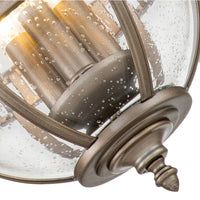 Outdoor bronze globe pendant light with clear seeded glass and classic lantern-style metal frame, IP44 rated for elegant exterior lighting.