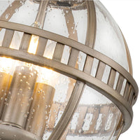 Outdoor bronze globe pendant light with clear seeded glass and classic lantern-style metal frame, IP44 rated for elegant exterior lighting.