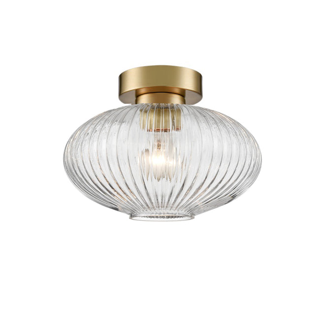 A modern semi-flush mount ceiling light fixture featuring a ribbed, clear glass shade in brushed brass.