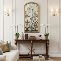 A stunning piece of mirrored wall art, a classic bird and flowers 'Victorian' style image on an arched mirror. The reflective surface creates a light enhancing focal point