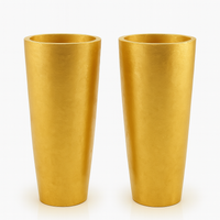 Pair of tall oversized gilt vases with tapered cylindrical shape and textured gold finish.